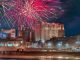 fireworks going off over the boardwalk in atlantic city with casinos in the background