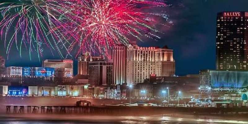 fireworks going off over the boardwalk in atlantic city with casinos in the background