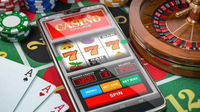 smartphone with online casino app among retail casino table game paraphernalia