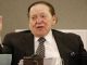 casino magnate sheldon adelson with his arms raised in exasperation