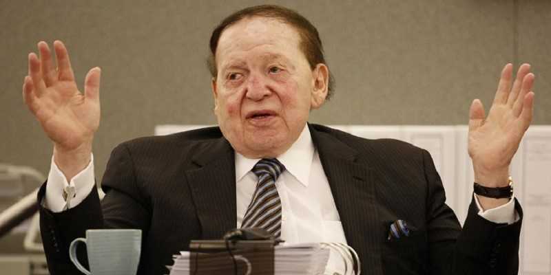 casino magnate sheldon adelson with his arms raised in exasperation