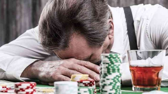 problem gambling is no joke unless you are a major us gambling brand man with head in hands at poker table