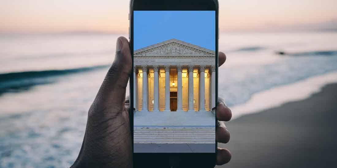 a cell phone watching the US Supreme Court on a Florida beach