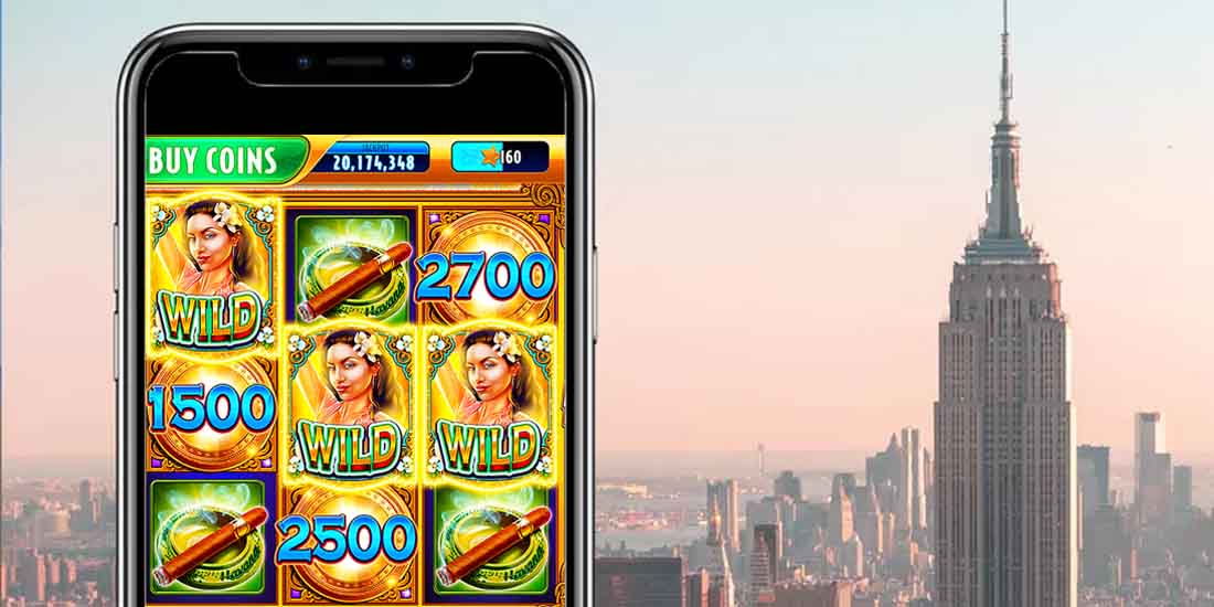 a mobile phone with a slots app with the Empire State Building in the background