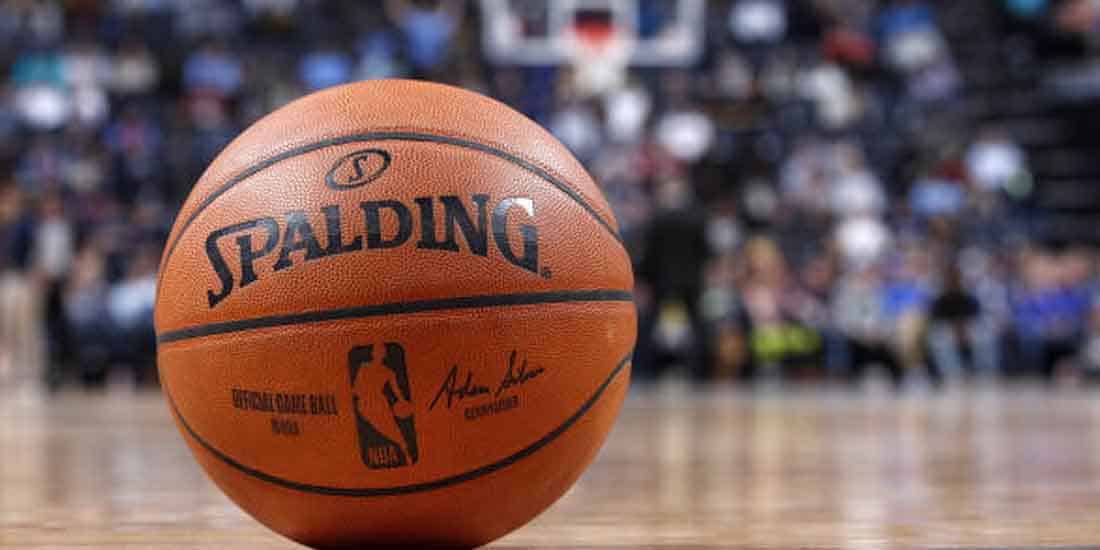 a close up of an NBA basketball resting on the court