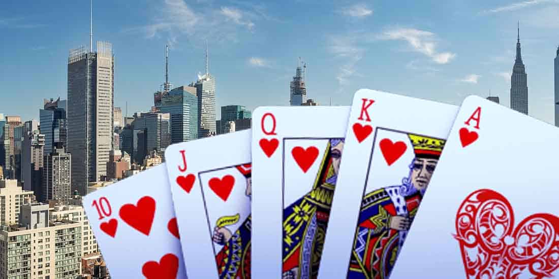 a royal flush in front of a Manhattan skyline